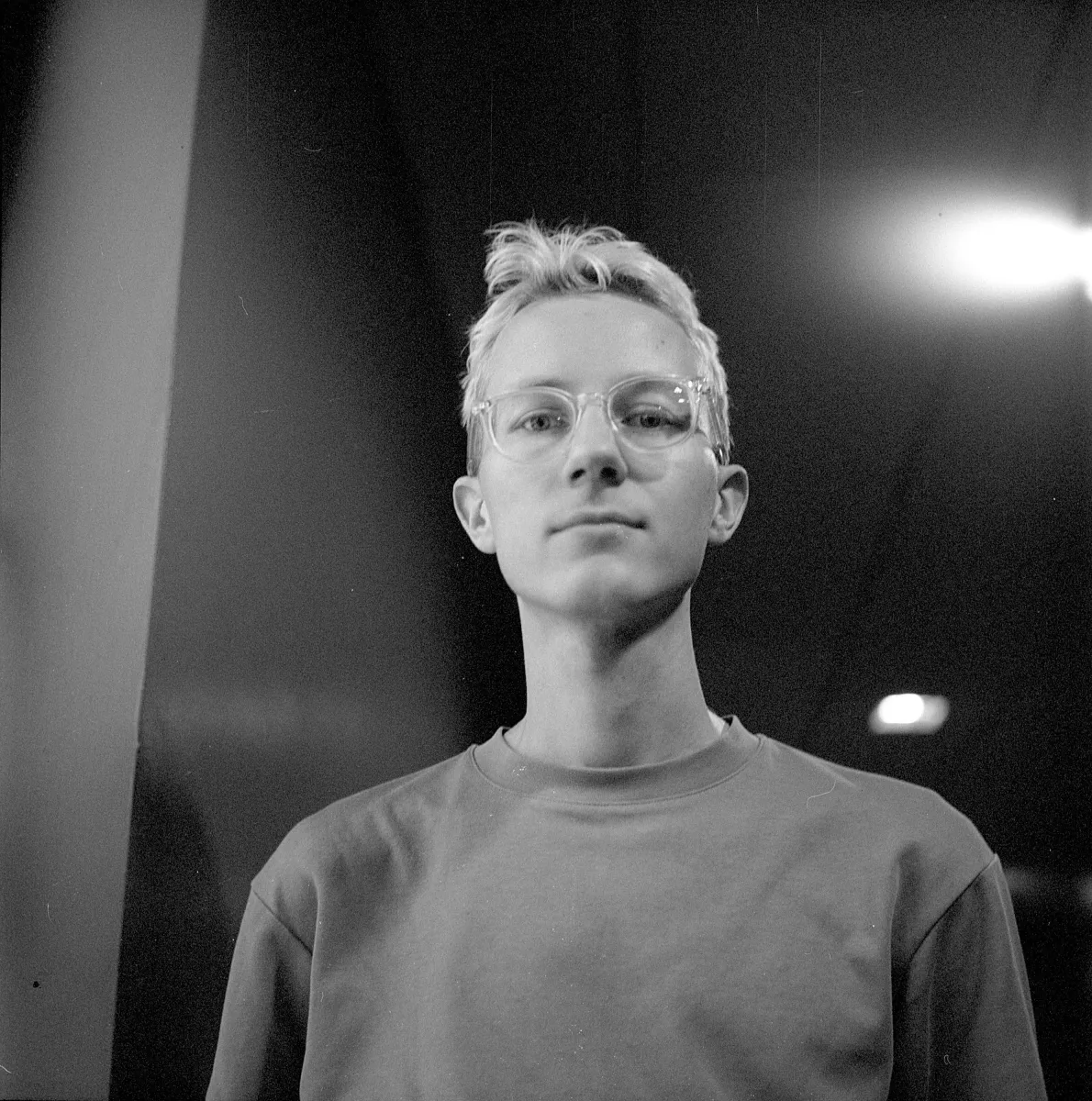 Black and white headshot of an adult man with blonde hair