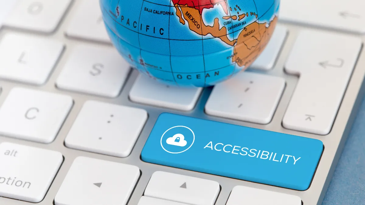 A globe sits on top of a computer keyboard with a blue key that reads "Accessibility"