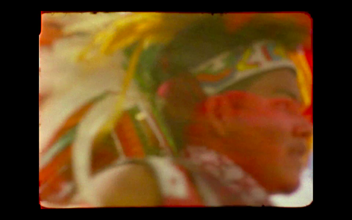 Still image from Colectivo Los Ingrávidos' "Tierra en Trance," showing the edges of a 16mm film still with a dancer wearing a traditional headdress.