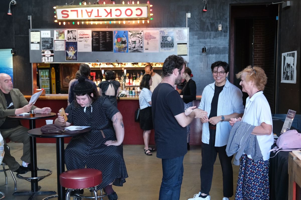 IDA members networking at a theater foyer