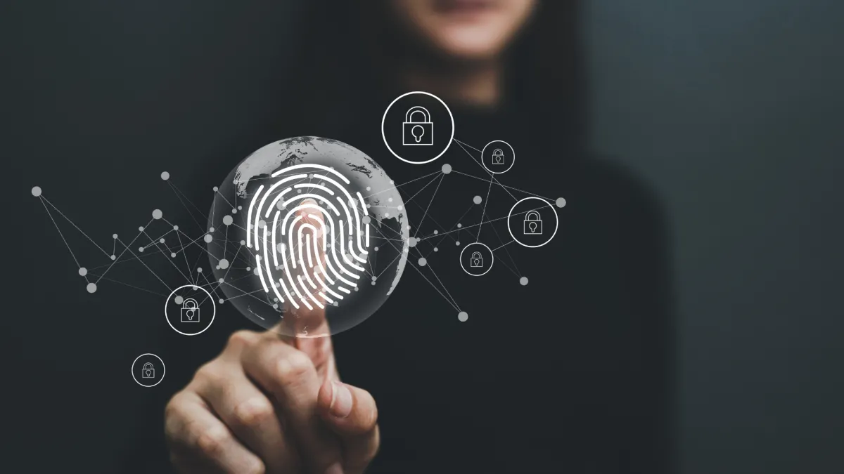 a woman holding her index finger on top of a screen with finger print illustration implying digital security