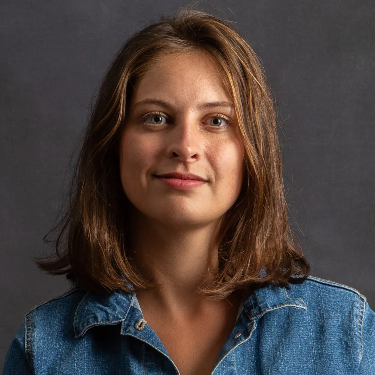 headshot of producer Colleen Cassingham wearing a blue jean shirt