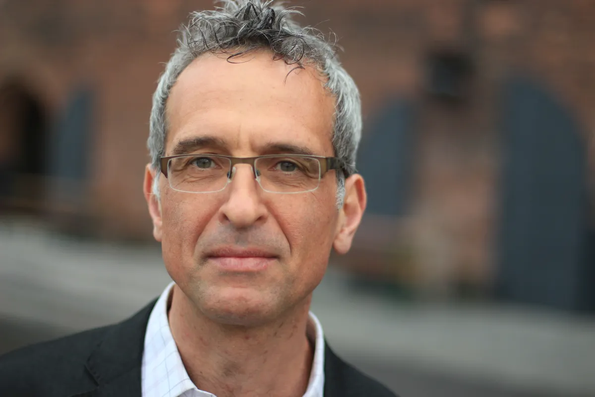 headshot of Filippo Piscopo wearing a black jacket with white shirt and glasses