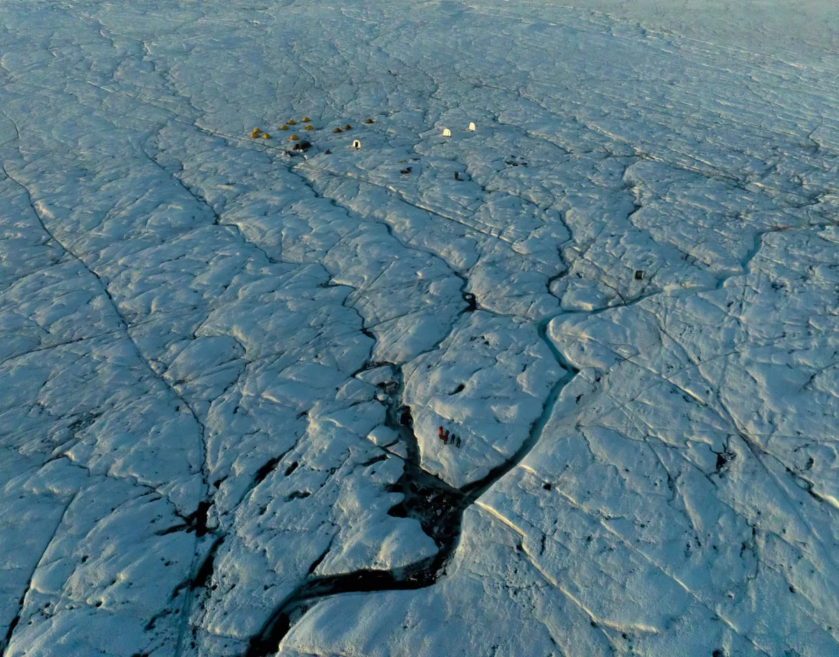 A Scientific Field Camp on The Greenland Ice Sheet, crisscrossed by crevasse traces and ice streams.