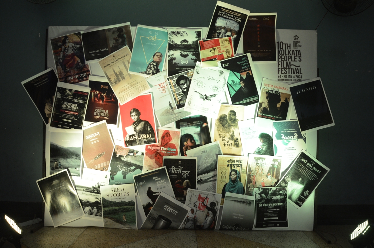 Poster wall, with 10th Kolkata People's Film Festival printed in the top right corner.