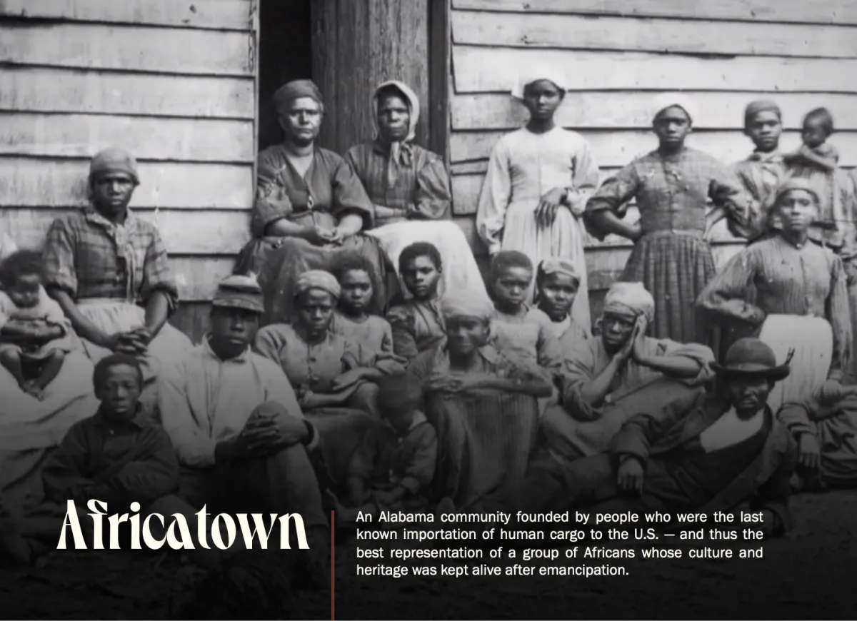 Black and white photograph of a group of enslaved African Americans standing in front of a building