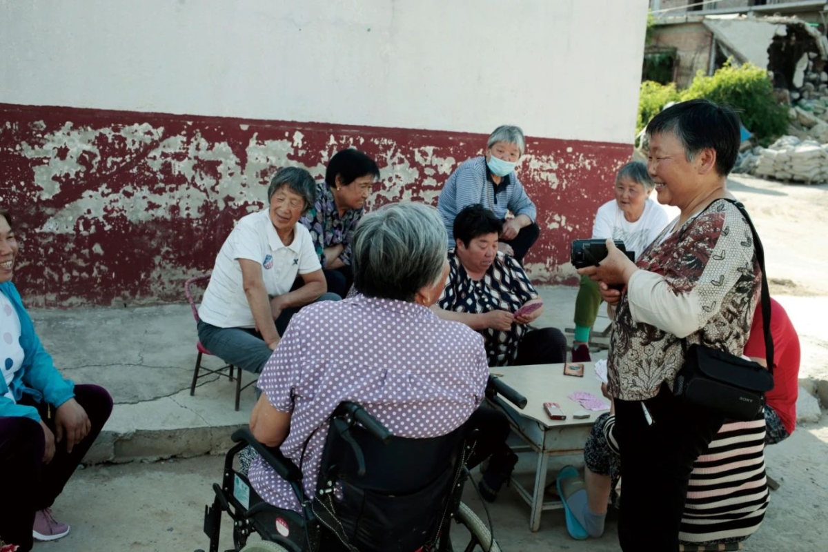 A group of middle-aged Chinese women talk to each other.