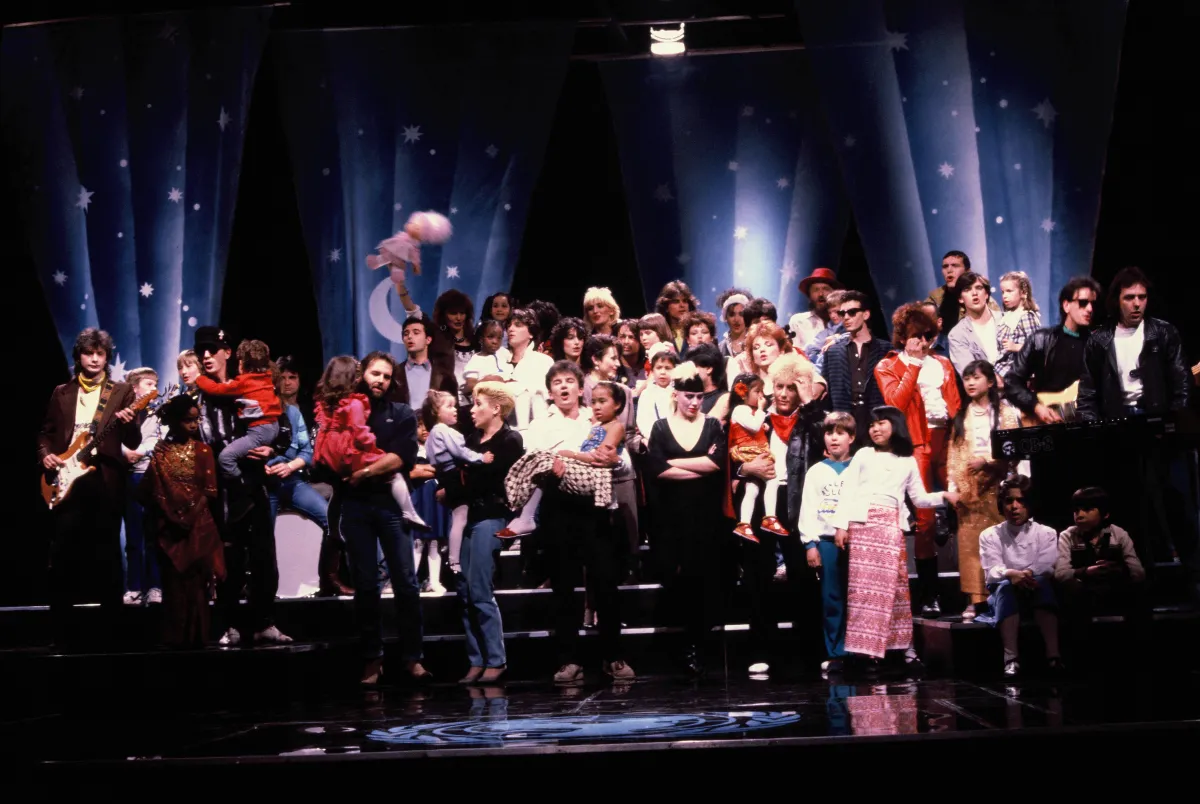 A large group of people celebrating on a stage