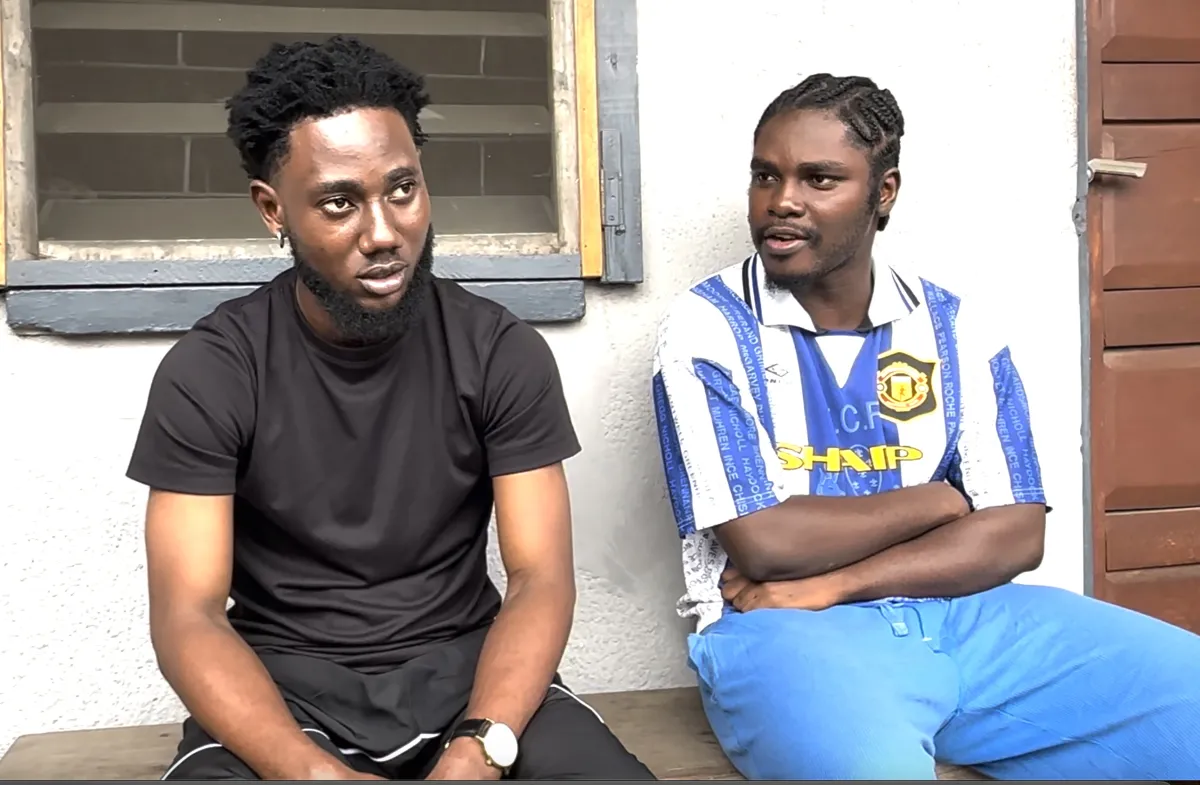 Two young men sitting on a veranda
