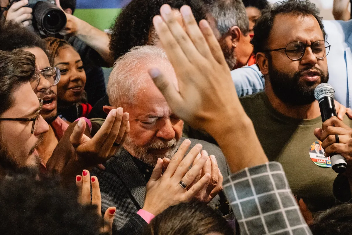Close up of a group of people praying together.