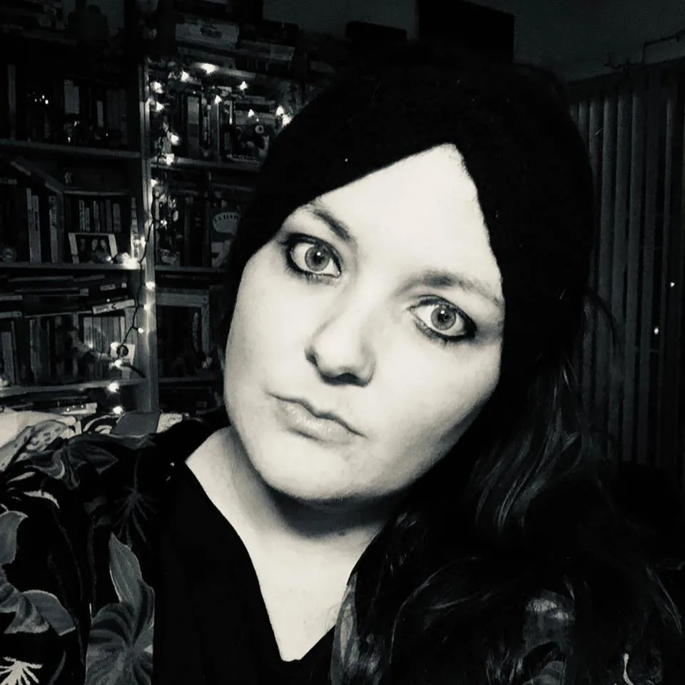 A woman with dark hair and lined cat eyes.