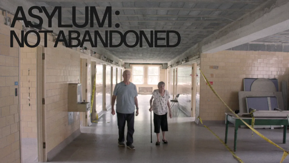 A senior aged brother and sister walking down the hallway of an empty wing at the Sheboygan County Hospital.