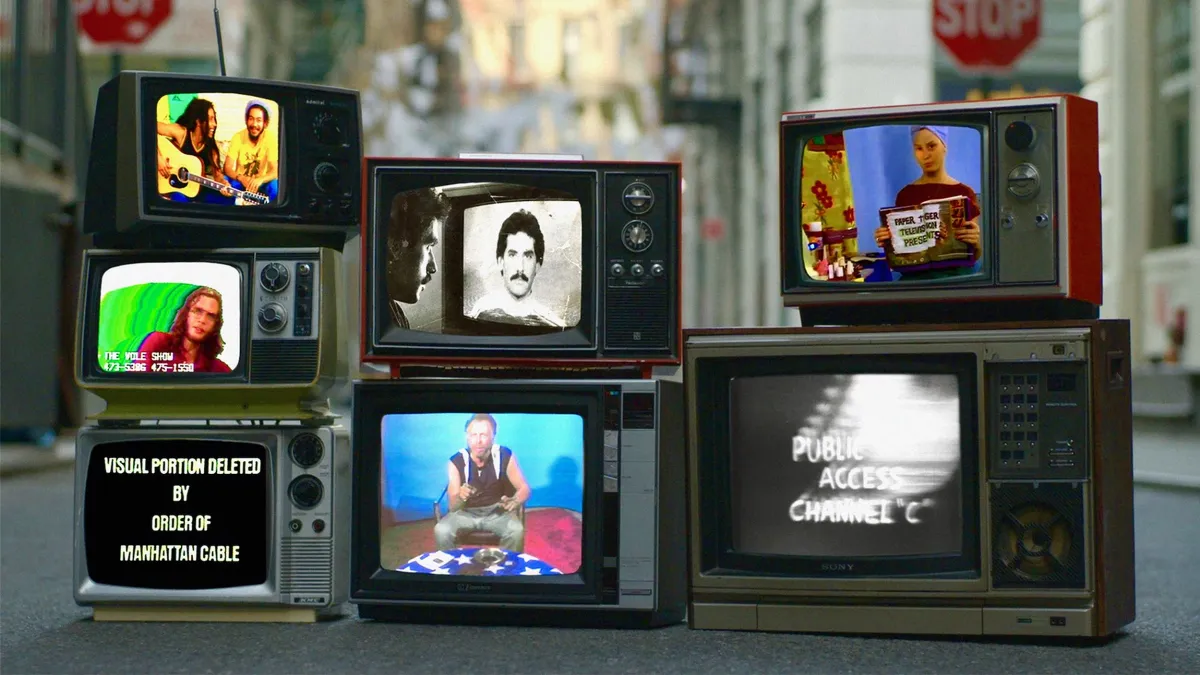 Various vintage television sets made to look like they're laying on the ground on a New York City street show scenes from public access Tv shows