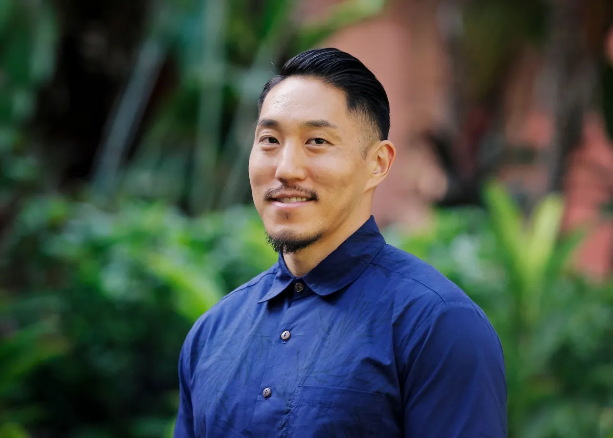 Headshot of Tadashi Nakamura. Asian man with a dark blue shirt.