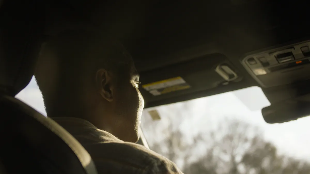 Close up of a man driving, shot from behind