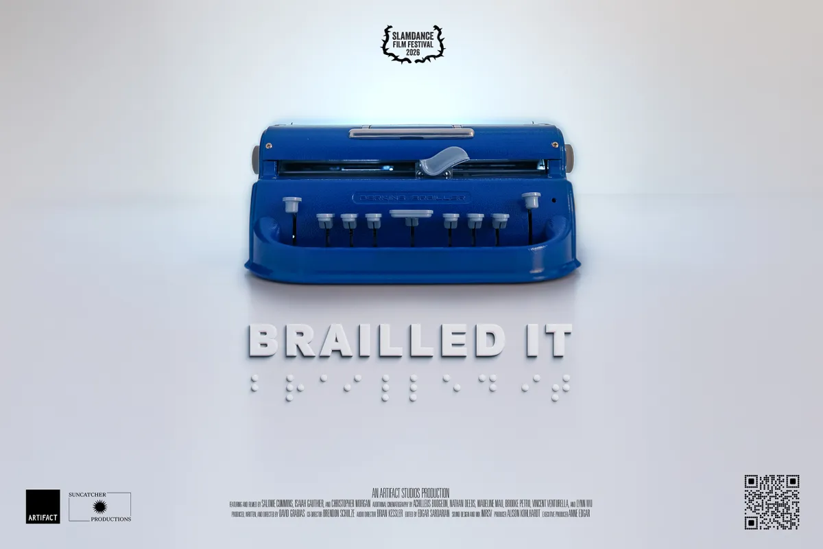 A blue Perkins brailler sits on a white backdrop. The film's title, Brailled It, is beneath the brailler in standard print and braille.