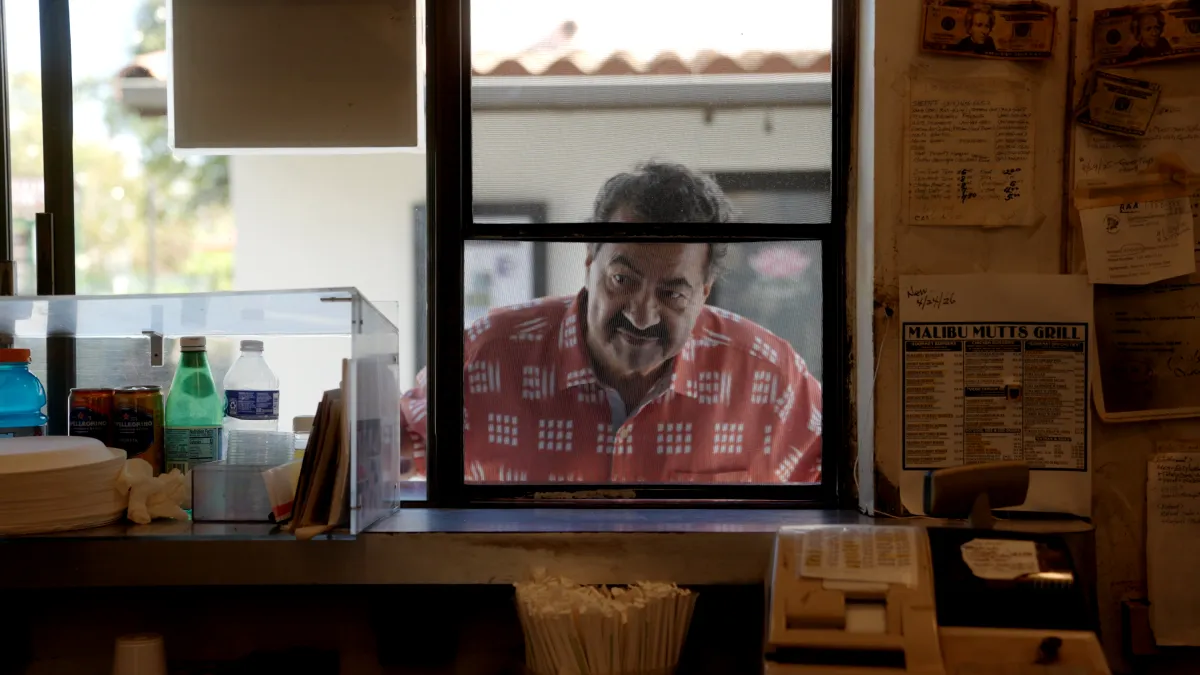 Ziad Karram peers through the front window of his old falafel shack, the Malibu Mutt.