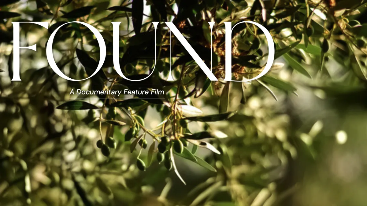 A close-up of a leafy branch of an olive tree with the words "FOUND: A Documentary Feature Film."
