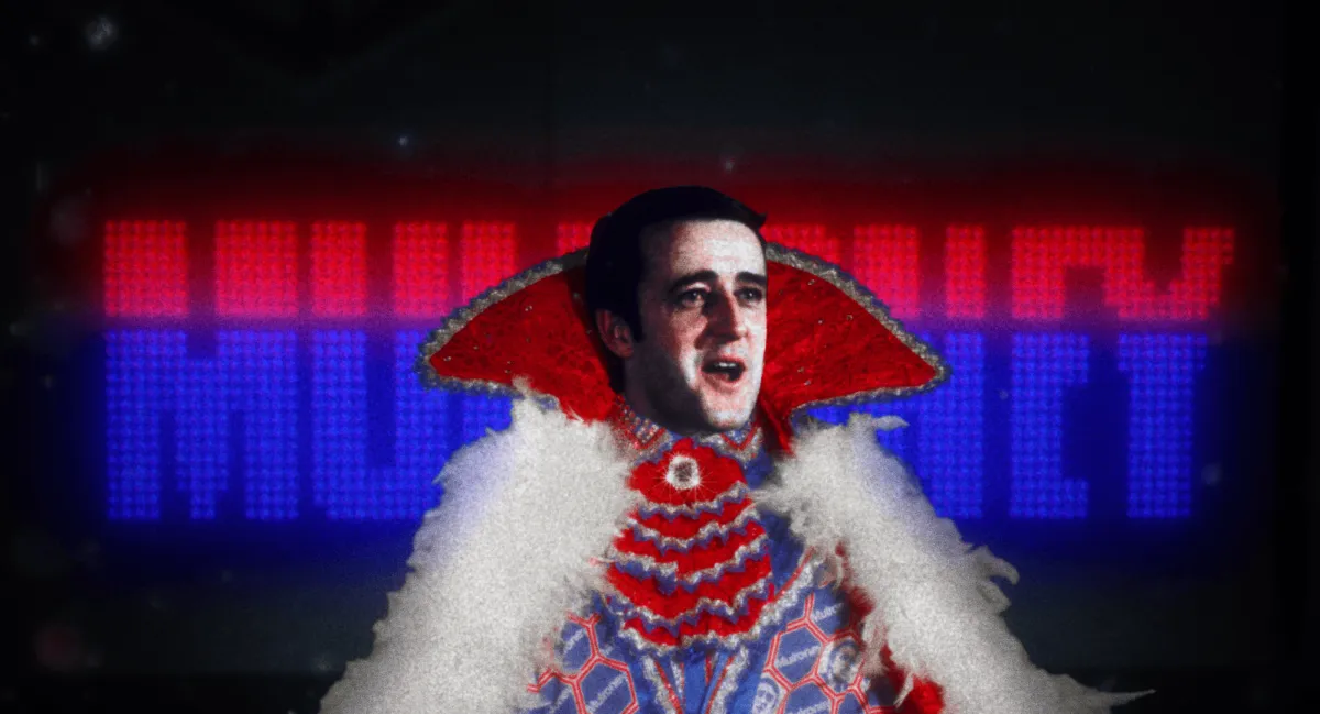 A man's face (Brian Mulroney) is inserted over a red cape with blue frills and white feathers, placed over a black background which displays the word MULRONEY, the bottom two-thirds of the text colored blue and the top two-thirds colored pink