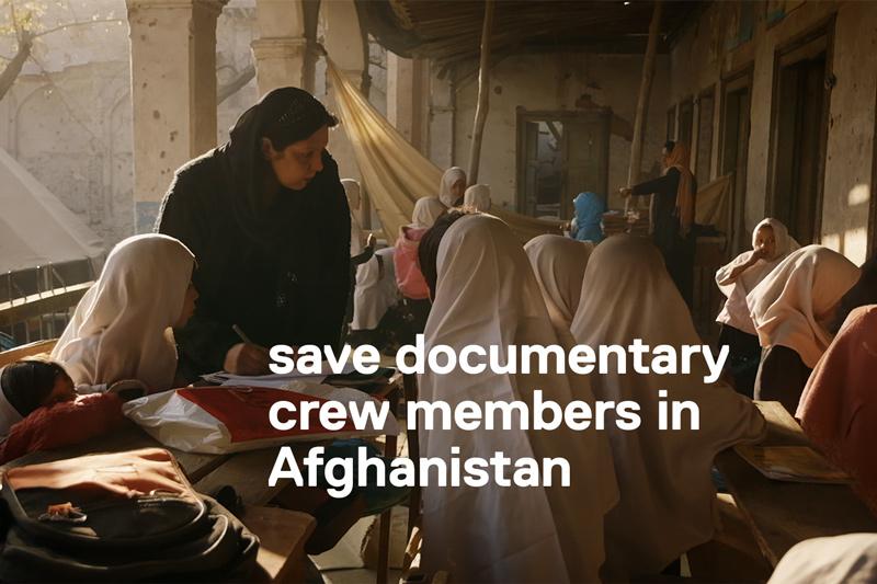 film still from 'Angels are Made of Light' of Afghan girls in school session in a courtyard.