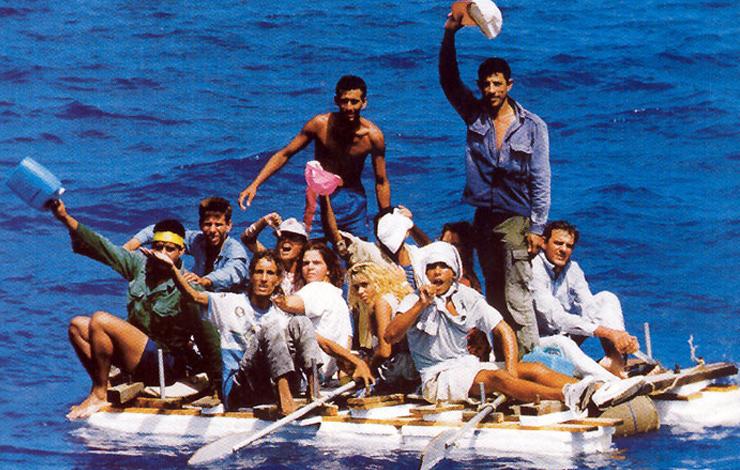 A group of young people balance on a raft, from Carlos Bosch's 'Cuba's Rafters [Balseros].'