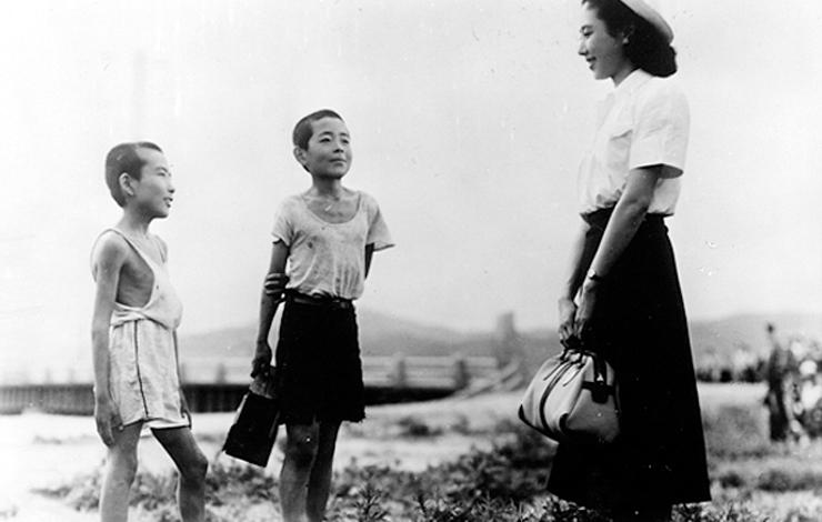 A Japanese woman talks with two young boys, from 'Children of Hiroshima.'