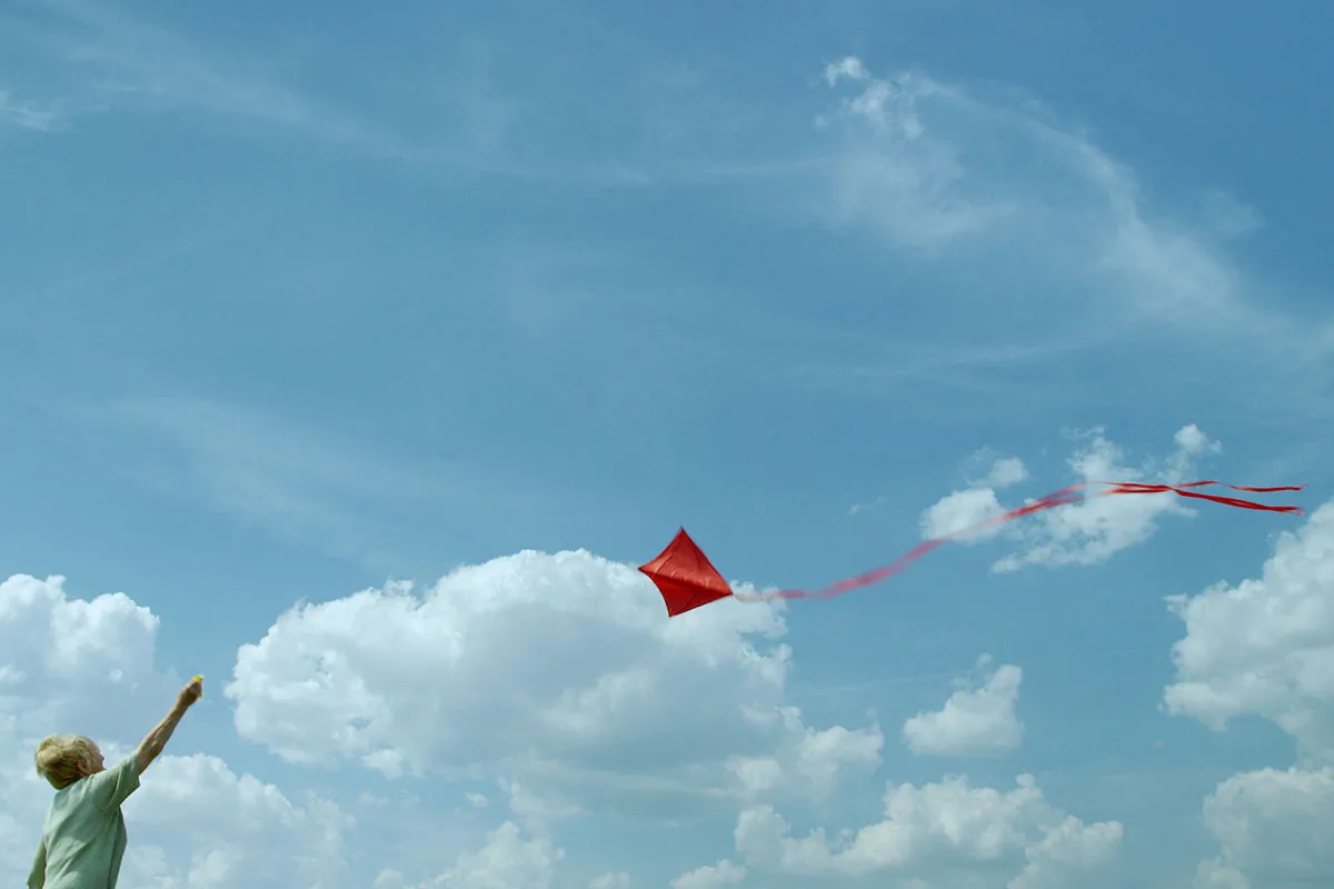  Rebecca is a elderly white woman flying a kite in Detroit, on a bucket list adventure. Image from Sian-Pierre Regis’ ‘Duty Free.’ Courtesy of PBS, Independent Lens.