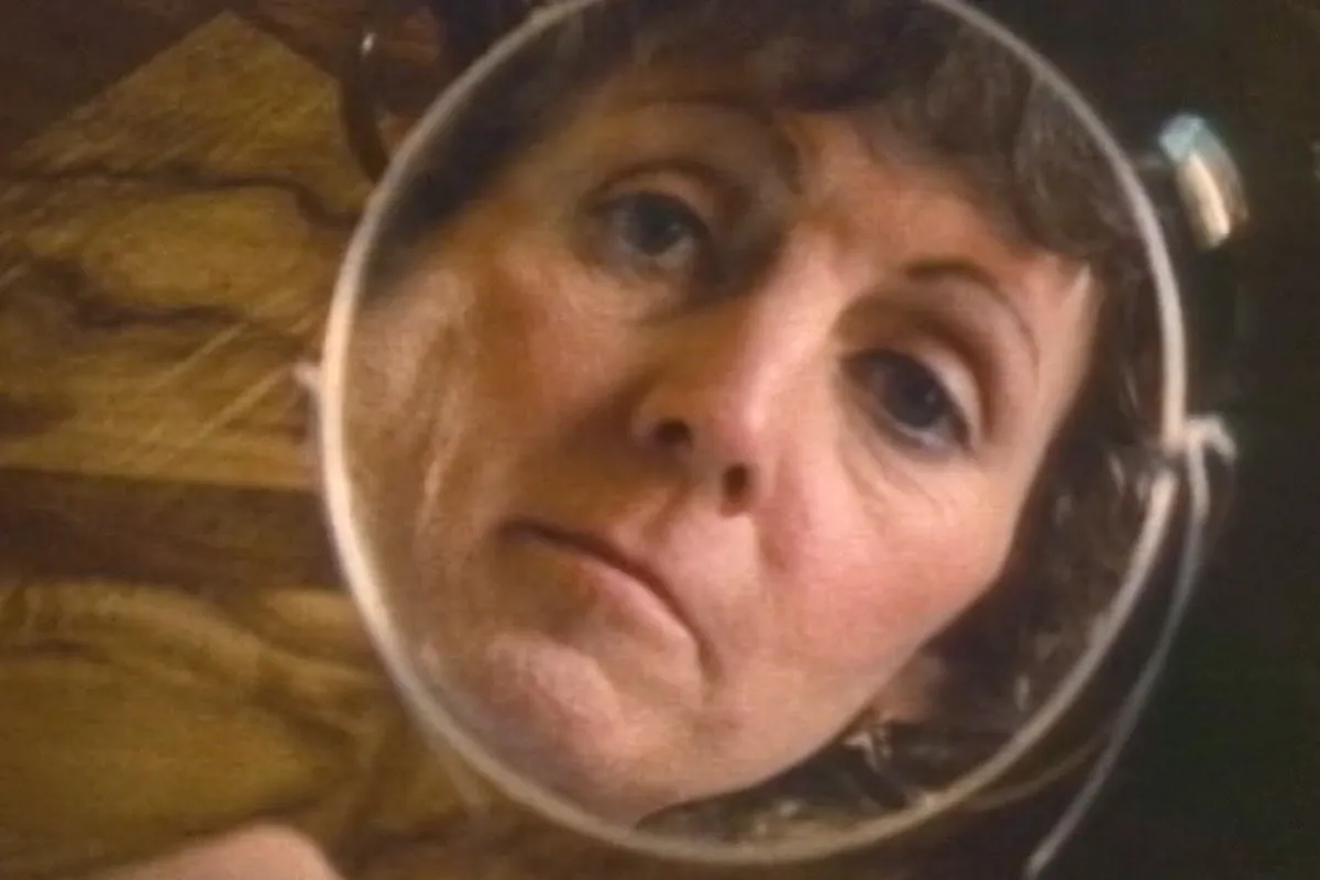 A protagonist looks into a hand-held mirror in Lee Grant's 'What Sex Am I?" Courtesy of Criterion Channel