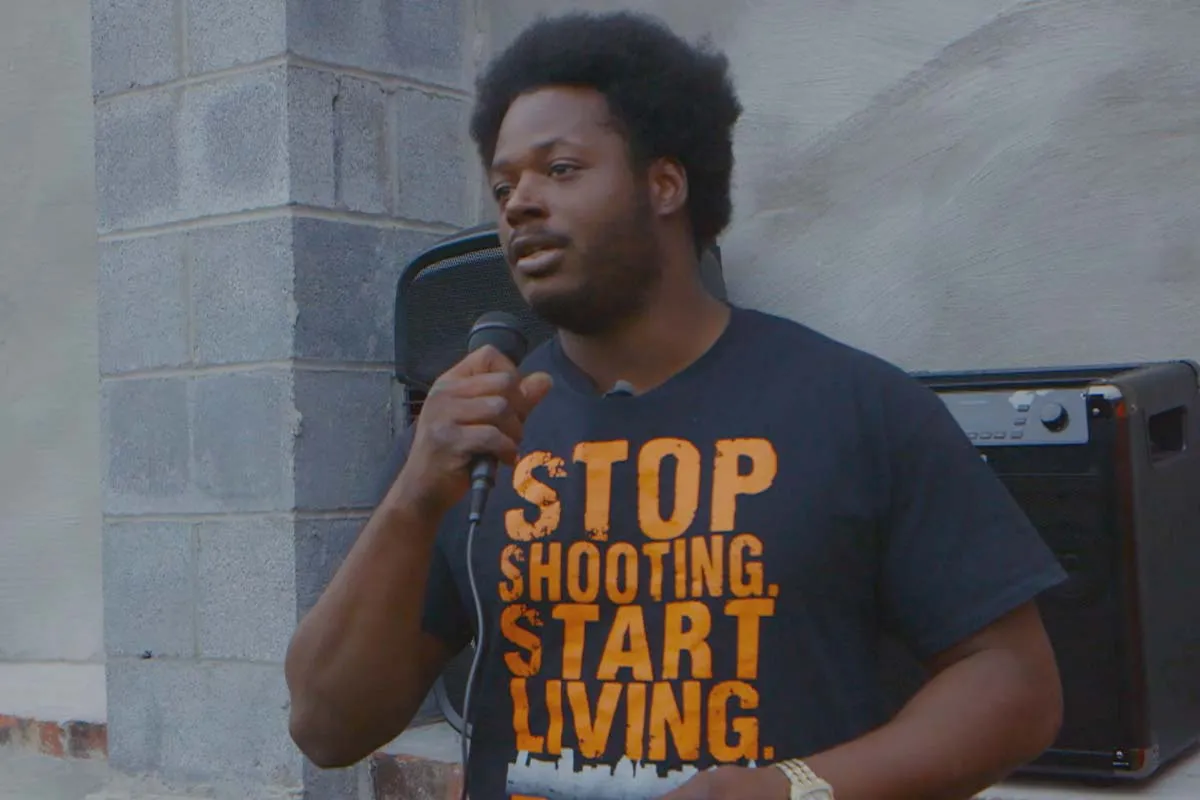 Alex Long of East Baltimore speaks at a community gathering about the need to stop gun violence. Photo courtesy of Andre Lambertson.