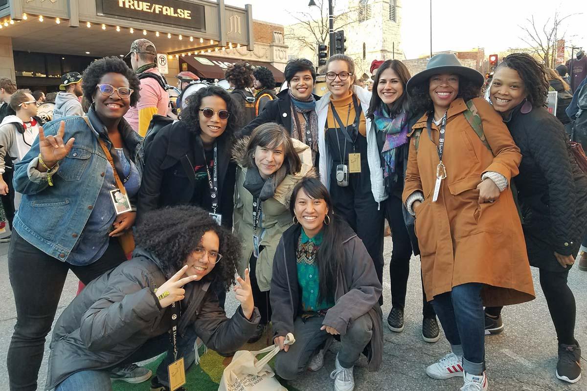 Iyabo Boyd (left), a Black woman with short hair and glasses, is standing with other women of color documentary professionals—all members of Brown Girls Doc Mafia—during True/False fest. Courtesy of Brown Girls Doc Mafia.