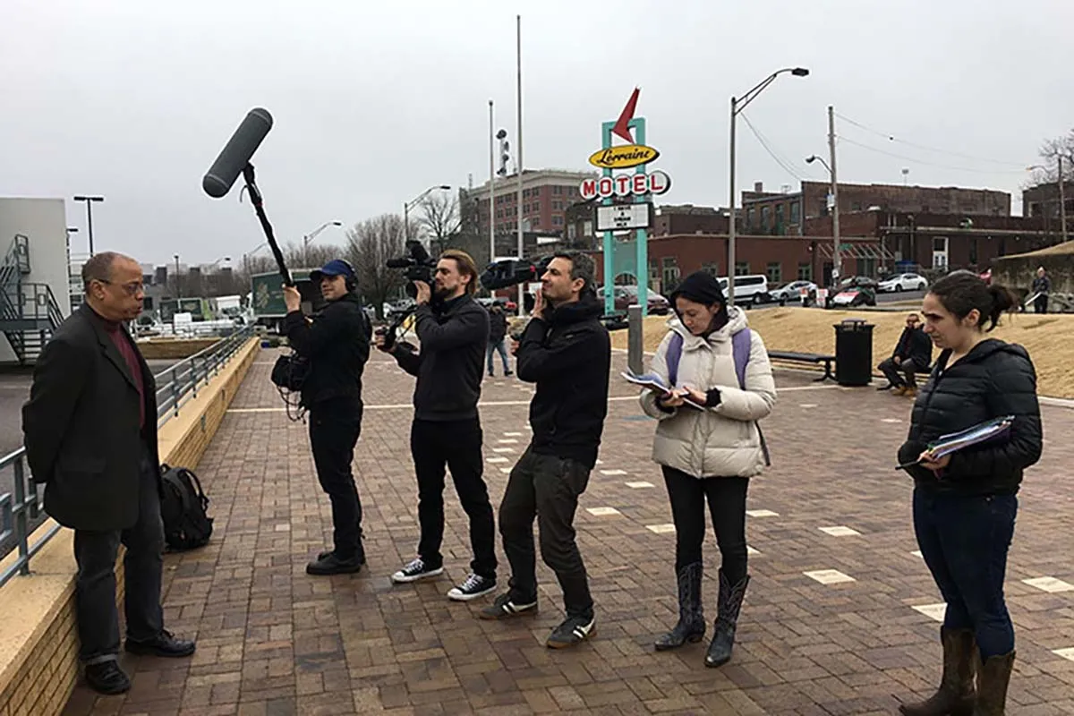 Members of the film crew—consisting of three white men and two women—of ‘Who We Are’ filming Jeffery Robinson—a Black man in a black blazer and pants—in front of Memphis’ Lorraine Motel. Photo courtesy of Sony Pictures.