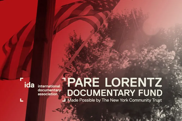 US flag on a pool under the sun with a tree in the background.