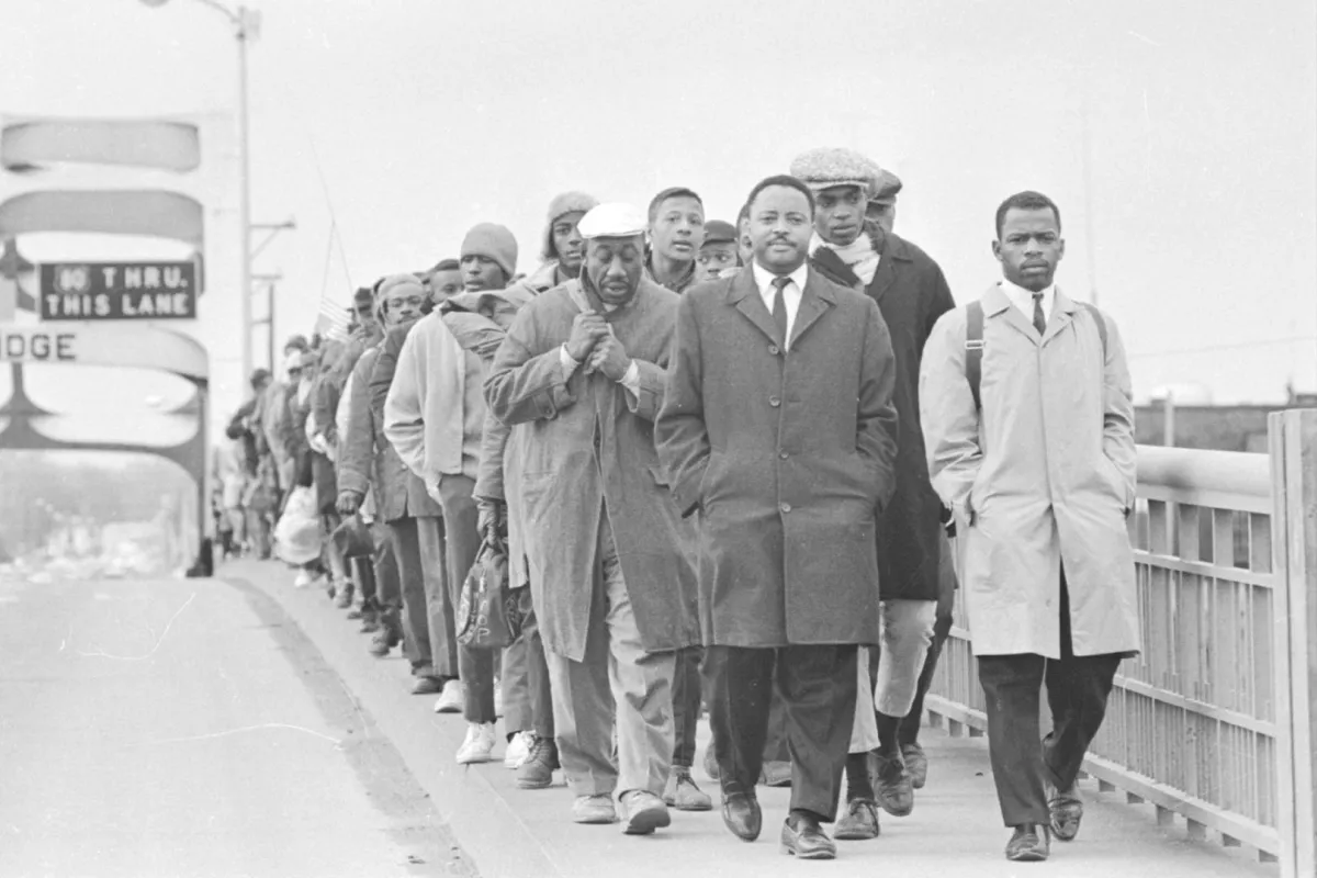 A group of Black man marching over a bridge