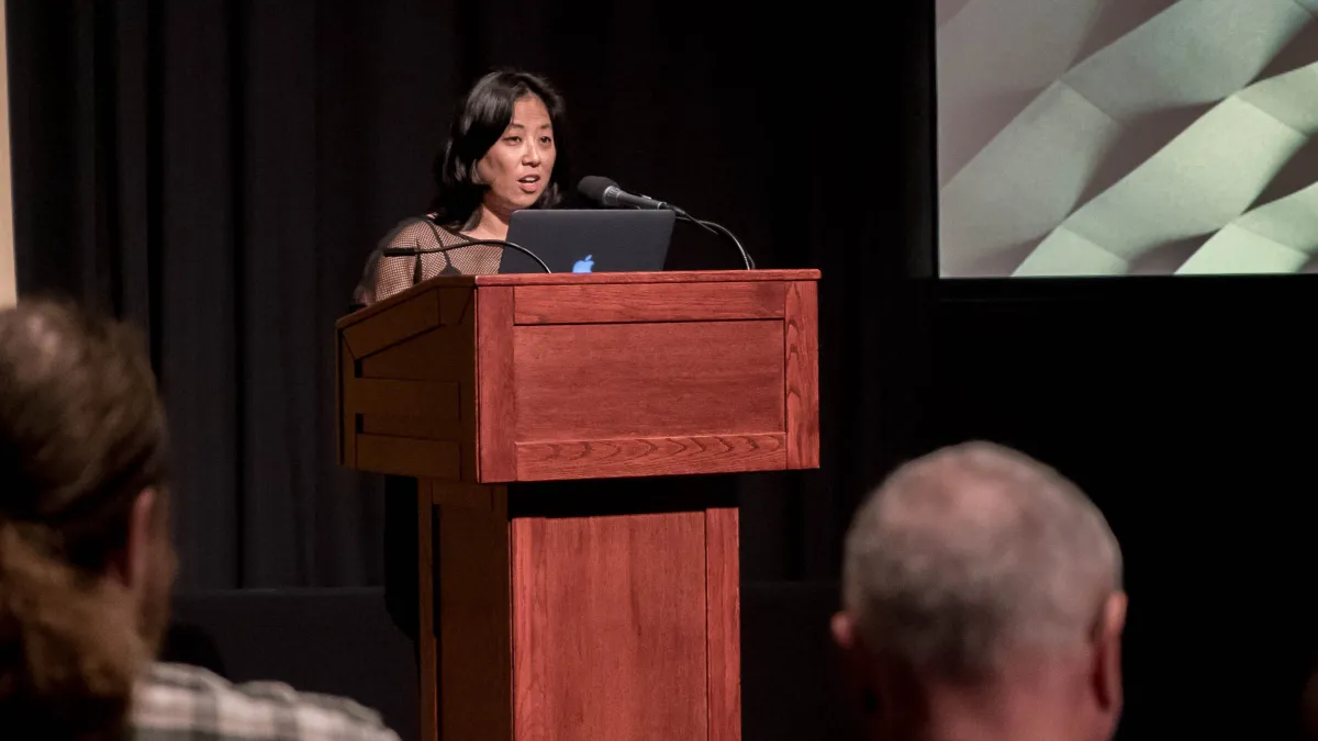 Grace Lee speaking behind the podium.