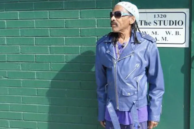 Teenie in front of the green brick walls of Royal Studios