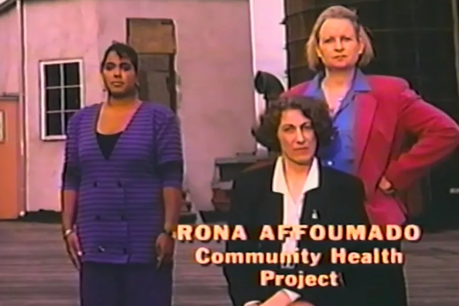 Rona Affoumado stands in front of fellow Community Health Project workers