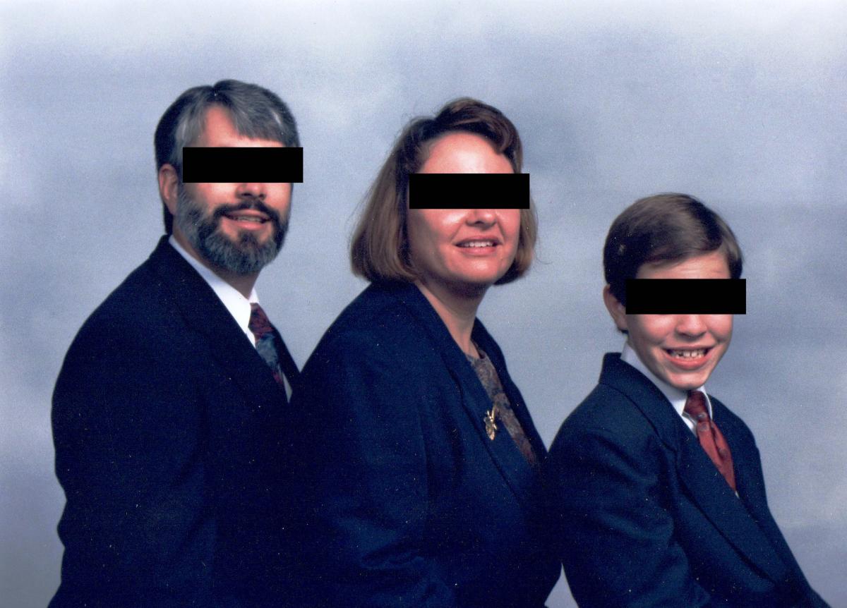 white couple with young son pose for family portrait with their eyes covered by black censor bars