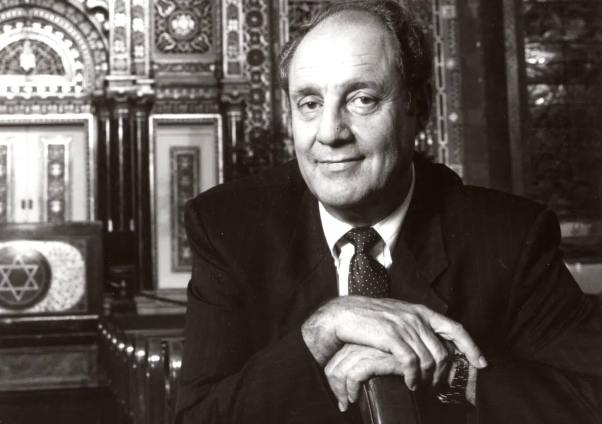 A headshot of Marshall Meyers sitting in a Synagogue 