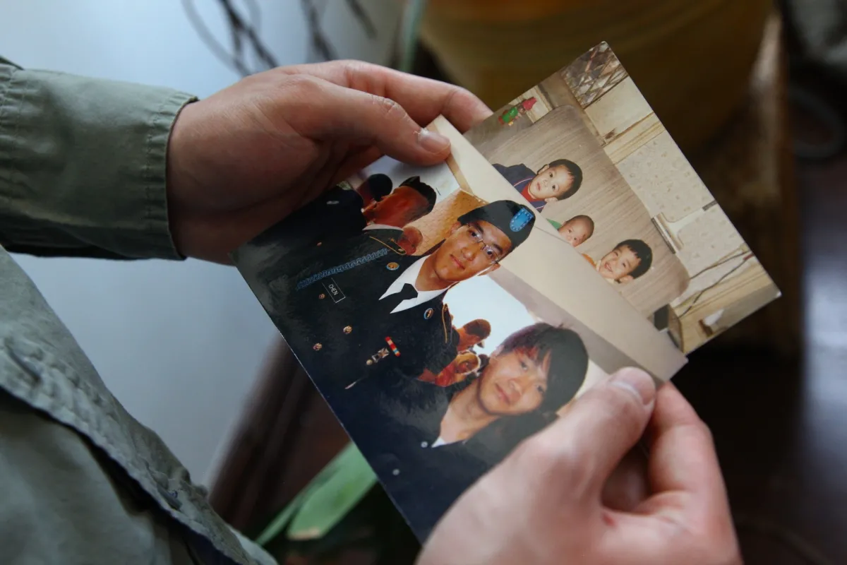 photo of hands holding image of a victim of hazing
