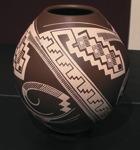 A vibrant brown patterned ceramic vase with geometric design