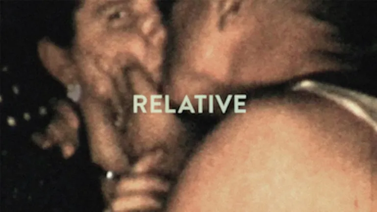 home video screenshot from 1940. Man kissing a woman as she looks into camera.