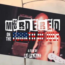 Still image from a film featuring a photo of a shirtless young Black man with a bald head. The photograph is balancing on a narrow branch. The words "Murdered on the Fourth of July, a Film by Pj Perez" are superimposed on the still image.