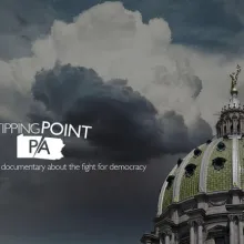 An image of a green dome with an American flag in the bottom right corner, and dark clouds in the background. The text "Tipping Point PA" is superimposed on the clouds in white text.