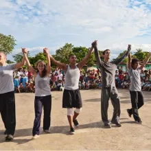 Five Juilliard Dancers performing in The Philippines, in front of a large crowd of children.