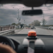 Still from 'In the Rearview,' depicting a view of a road blockade from the inside of a van.