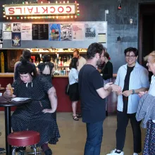 IDA members networking at a theater foyer