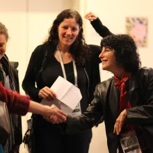 Photograph of Nancy Buirski greeting festival guests, with Laura Poirtras looking on, at Full Frame in 2009. Photo credit: Steve Bognar