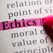 The word "Ethics" highlighted with pink marker on a book page