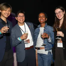 IDA member and staff holding drinks at a FallDocs reception. Left to Right: IDA member, IDA staff Armando Zamudio, IDA staff Keisha Knight, IDA volunteer 