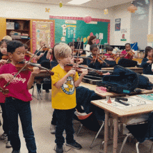 A music teacher instructs a classroom full of second graders holding violins.